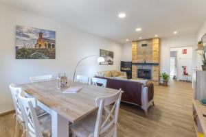a dining room and living room with a table and a couch at Chalet Pinara in El Barraco