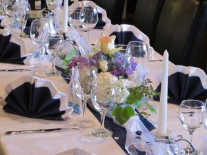 a table with wine glasses and flowers on it at Landgasthof Löwen in Tübingen