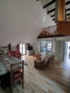a large living room with a bed and a couch at Grand Duplex 9 pers-Centre de La Bourboule in La Bourboule