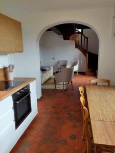 a kitchen and living room with a table and a dining room at Au cerisier in Saint-Maulvis +13 photos