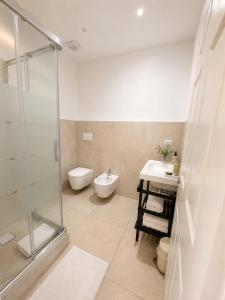 a bathroom with a shower and a toilet and a sink at Canneddi Boutique Farm in Avetrana +47 photos