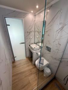 a bathroom with a sink and a toilet and a mirror at ΑVLI Sarti Superior Studio no5 in Sarti +8 photos
