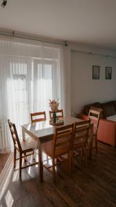 a living room with a table and chairs and a couch at Gacka idila in Otočac +39 photos