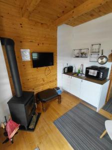 a living room with a stove and a kitchen at A-frame Đukić in Jajce