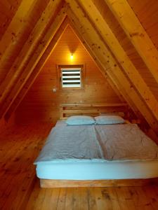 a bed in the attic of a cabin at A-frame Đukić in Jajce