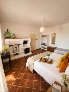 a large room with a bed and a fireplace at Canneddi Boutique Farm in Avetrana