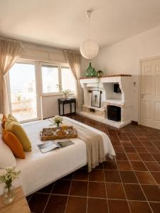 a large bedroom with a bed and a fireplace at Canneddi Boutique Farm in Avetrana