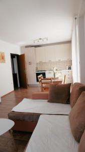a living room with a couch and a kitchen at Gacka idila in Otočac