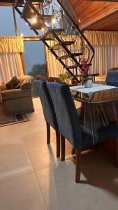 a dining table and chairs in a room with a view at Chale Pedra do Sol in Caxias do Sul