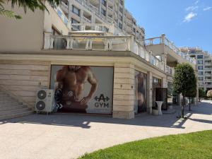 a building with a large advertisement on the side of it at Coral Bay Studio Varna - Beachfront with Free Parking in Varna City