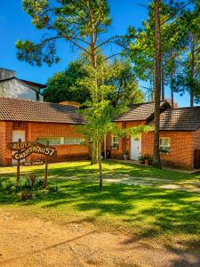 a brick building with a sign in front of it at Complejo Aldea Champaqui in Villa General Belgrano