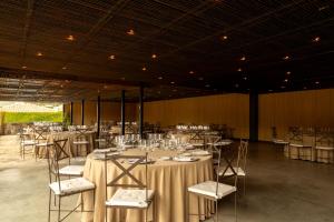 a banquet hall with tables and chairs in it at Belle Torre Mayorazgo Boutique Hotel in Villatoro