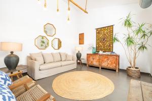 a living room with a couch and a table at Villa Palma - Establiments by PriorityVillas in Palma de Mallorca