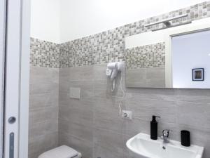 a bathroom with a sink and a toilet and a mirror at Guest House Maramà in Belvedere Marittimo +20 photos
