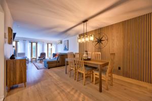 a dining room and living room with a table and chairs at Le Summit in Mont-Tremblant