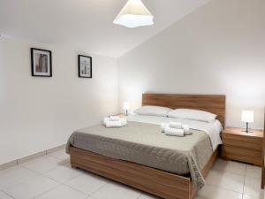 a bedroom with a large bed and two night stands at Guest House Maramà in Belvedere Marittimo