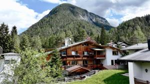 a resort with a mountain in the background at Emmat Apartments in Leutasch