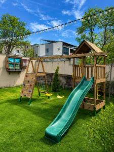 a playground with a slide and a climbing frame at Aurelia Hotel & Restaurant in Dilijan