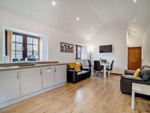 a kitchen and living room with a table and chairs at 2 Bed in Bristol oc-72837 in Chew Magna +8 photos