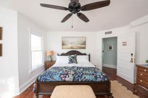 a bedroom with a bed and a ceiling fan at The Parrish Grove Inn in Cocoa