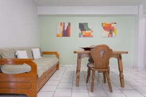 a bedroom with a bed and a table and a chair at Arches in Agria