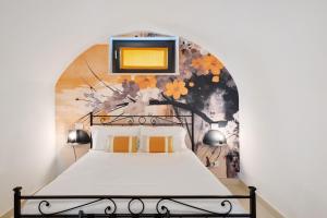 a bedroom with a bed with a painting on the wall at Agriturismo Cascina Capo in Negrar