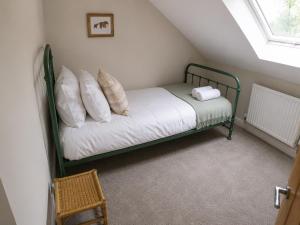 a bedroom with a green bunk bed with pillows at Storm View in Castletown