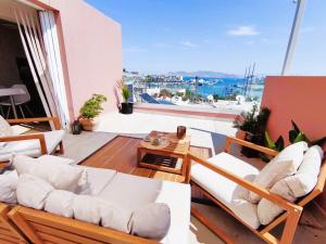 a balcony with white furniture and a view of the ocean at Dorian in Kos