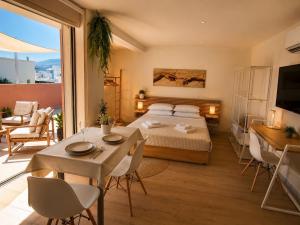 a bedroom with a bed and a table and chairs at Dorian in Kos