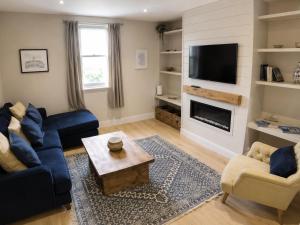 a living room with a blue couch and a tv at Storm View in Castletown