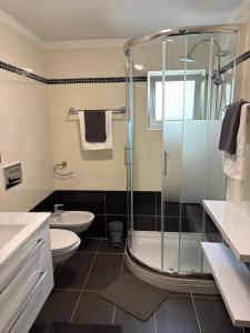 a bathroom with a shower and a toilet and a sink at Matea in Plomin +30 photos