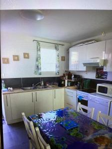 a kitchen with a table and a kitchen with a sink at Celimène in Canet-en-Roussillon