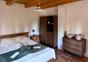 a bedroom with a bed and a dresser and a lamp at The Szigliget Residence in Szigliget
