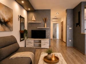 a living room with a couch and a television at Johanan 2 in Makarska