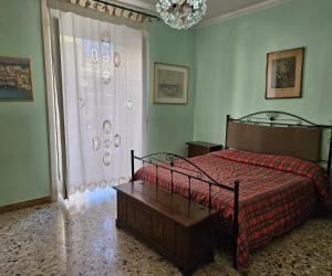 a bedroom with a bed and a large window at Appartamento in Centro casa vacanza in Scicli