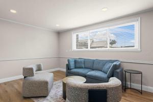 a living room with a blue couch and a chair at Newly Renovated Unit in Central Spfld #101 in Springfield