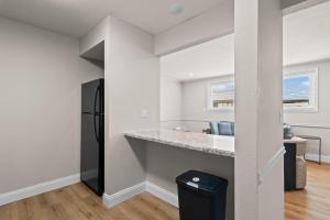 a kitchen with a counter and a refrigerator at Newly Renovated Unit in Central Spfld #101 in Springfield +10 photos