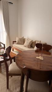 a living room with a table and a couch at ValdOrea Residences in Entebbe
