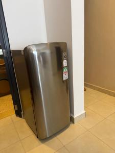 a stainless steel refrigerator sitting in a room at ValdOrea Residences in Entebbe