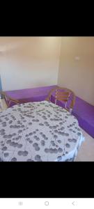 a bedroom with a bed with a purple mattress at Saïdafriends in Saïdia