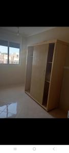 a empty room with a cupboard in a room with a window at Saïdafriends in Saïdia