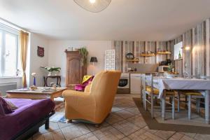 a living room with a table and a dining room at Maison de La Beslière meublé de tourisme 2 étoiles in Folligny