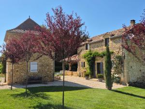 an external view of a stone house with a yard at Le Bos Dordogne in Soulaures