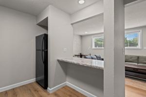 a kitchen with a black refrigerator in a room at Newly Renovated Unit in Central Spfld #103 in Springfield