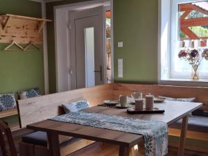 a dining room with a table and a window at Ferienhaus zum Eiskeller in Stadt Wehlen