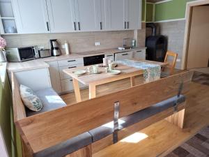 a kitchen with a wooden table in a kitchen at Ferienhaus zum Eiskeller in Stadt Wehlen