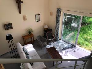 a living room with a white couch and a window at Gîte entre l'océan et le golfe in Surzur +7 photos