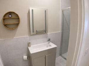 a bathroom with a sink and a mirror at Storm View in Castletown +9 photos