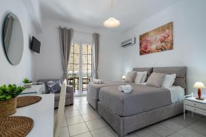 a bedroom with a bed and a couch at Aspasia Studios in Lixouri
