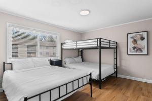 a bedroom with two bunk beds and a window at Newly Renovated Unit in Central Spfld #203 in Springfield